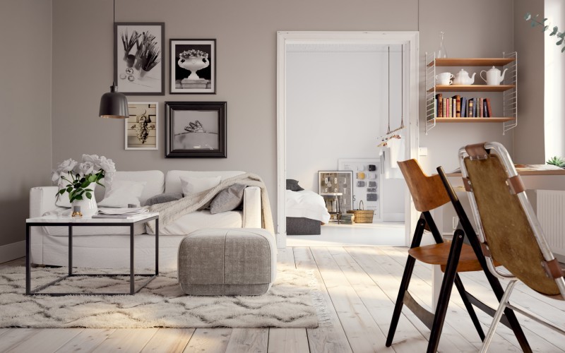Helles, stilvoll eingerichtetes Wohnzimmer mit weißem Sofa, Holzboden, Wandbildern und Blick ins Schlafzimmer